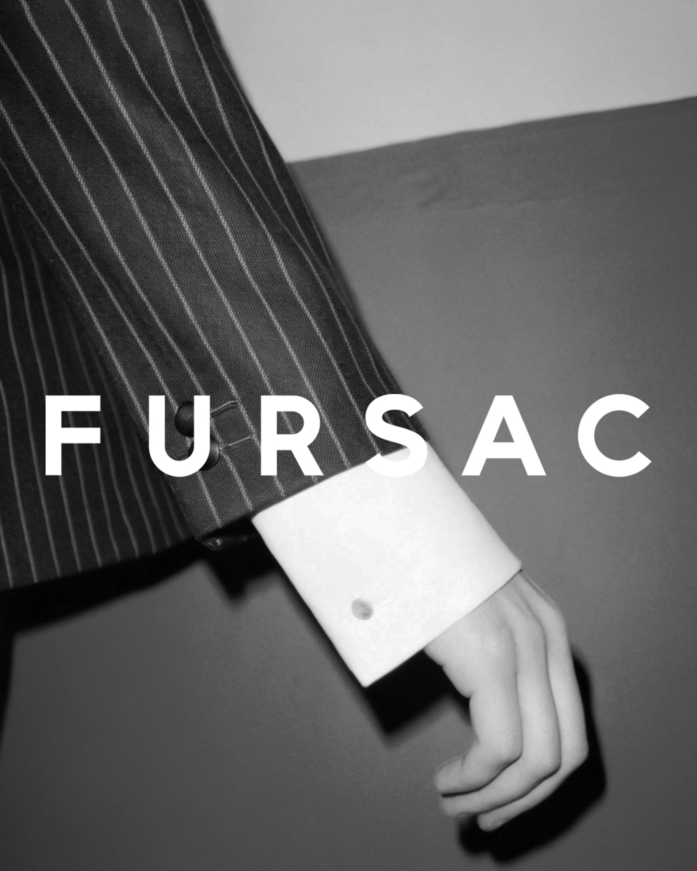 Black and white AI image of a pinstripe suit sleeve over a white French cuff, with the Fursac wordmark. Fursac AI Concept.