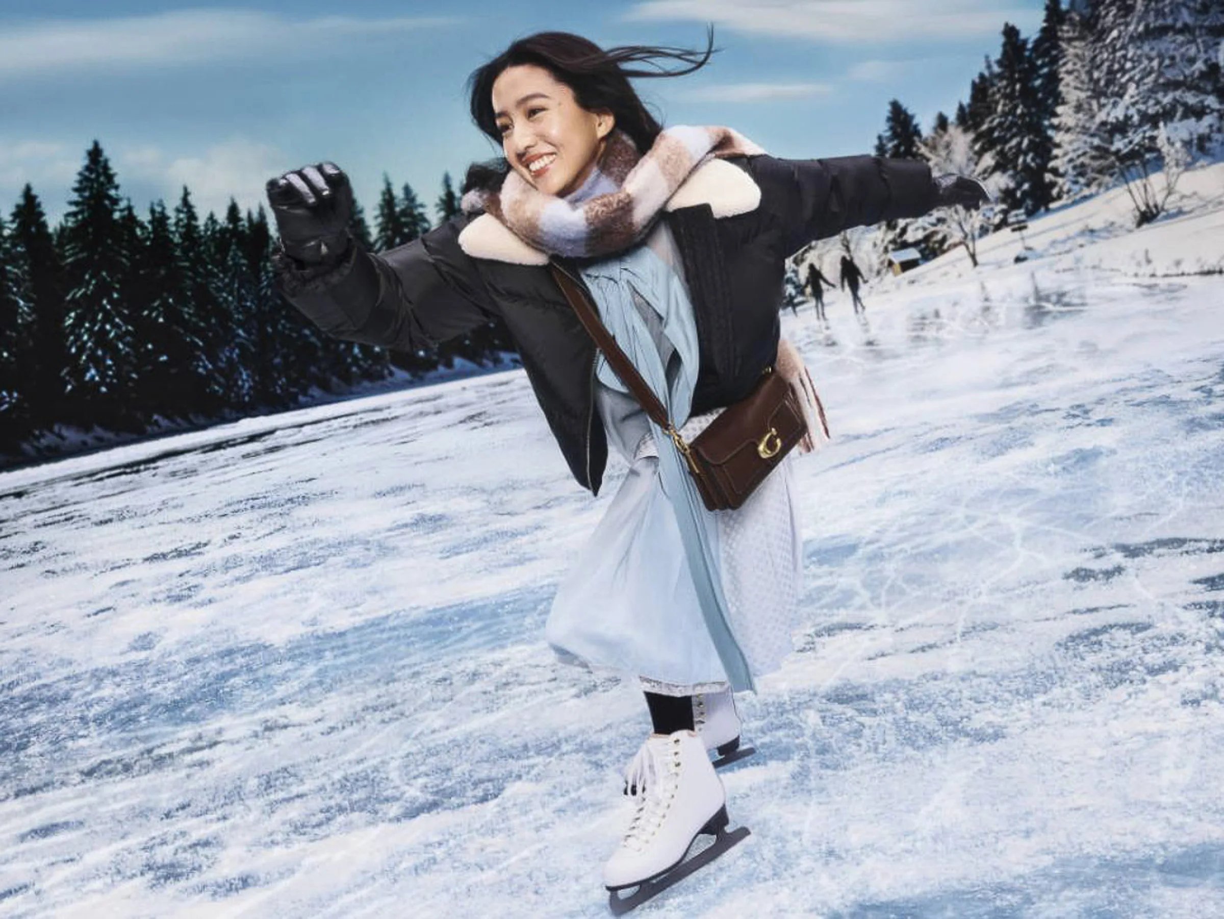 AI image of a woman ice skating on a frozen lake in a black puffer, plaid scarf and brown leather crossbody bag, for Coach.